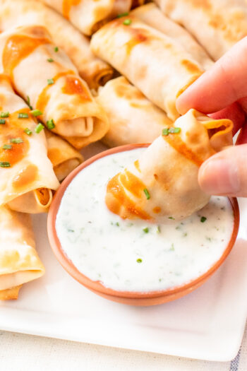 These Vegan Buffalo Chicken Mini Egg Rolls are the perfect party snack. These bite-sized appetizers are served with vegan ranch & extra hot sauce | ThisSavoryVegan.com #thissavoryvegan #veganeggrolls #gamedaysnacks