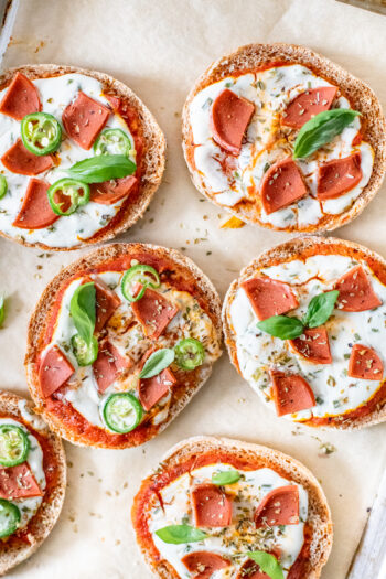 These Vegan English Muffin Pizzas are kid-friendly but adult approved. Make these in the air fryer or the oven & add your favorite toppings | ThisSavoryVegan.com #thissavoryvegan #veganpizza #englishmuffinpizza