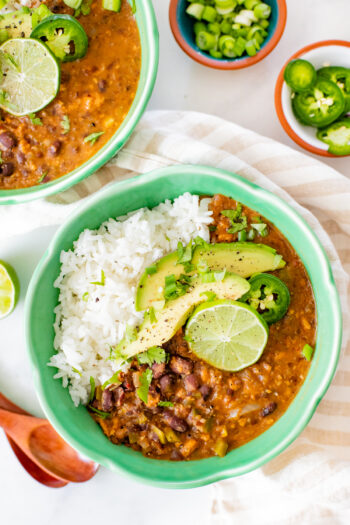 Perfect for a cold weeknight, this Slow Cooker Black Bean Soup is healthy, comforting and packed full of fiber and protein. Spice it up with your fave toppings | ThisSavoryVegan.com #thissavoryvegan #slowcookerrecipes #slowcookersoup