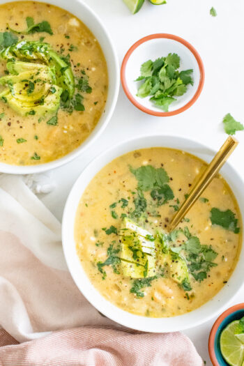 Quick, easy and delicious this Slow Cooker White Bean Enchilada Soup is the perfect vegan weeknight dinner! Stove top instructions included as well | ThisSavoryVegan.com #thissavoryvegan #slowcookerrecipe #vegansoup
