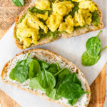 Make brunch at home with these Vegan Pesto & Egg Breakfast Sandwiches. The perfect combo of vegan eggs, cream cheese, spinach & pesto | ThisSavoryVegan.com #thissavoryvegan #veganbrunchideas #veganbreakfastideas