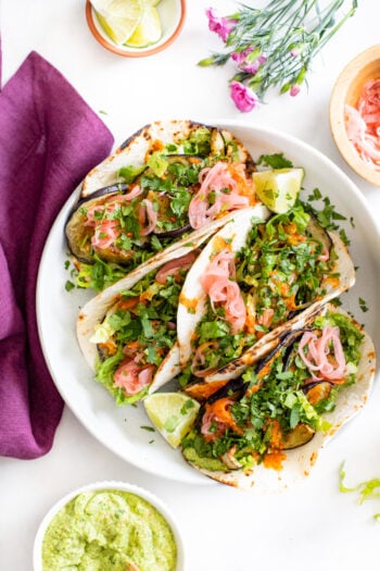 These Roasted Eggplant Vegan Tacos are layered with a creamy herb sauce, pickled onions, romaine and a drizzle of hot sauce | ThisSavoryVegan.com #thissavoryvegan #vegantacos #eggplantrecipes