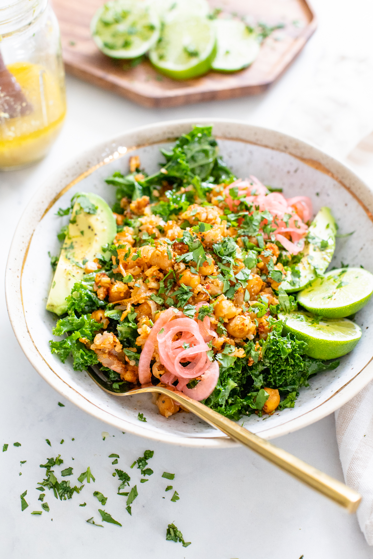 These Sheet Pan Harissa Cauliflower Rice Bowls are a burst of flavors. From the roasted chickpeas & cauliflower rice to the marinated kale. This recipe is a great healthy dinner | ThisSavoryVegan.com #thissavoryvegan #cauliflowerricerecipes #healthyvegandinners
