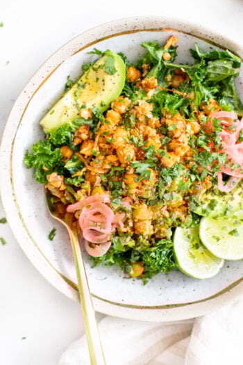 These Sheet Pan Harissa Cauliflower Rice Bowls are a burst of flavors. From the roasted chickpeas & cauliflower rice to the marinated kale. This recipe is a great healthy dinner | ThisSavoryVegan.com #thissavoryvegan #cauliflowerricerecipes #healthyvegandinners
