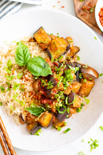 This Sweet and Spicy Braised Eggplant is tender and saucy. Adjust the spice to your taste and serve over coconut rice for a tasty dinner | ThisSavoryVegan.com #thissavoryvegan #eggplantrecipes #vegandinner