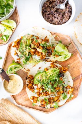 These Tempeh Soyrizo Vegan Tacos have a crispy tempeh filling, refried beans and a habanero cream sauce that adds so much flavor | ThisSavoryVegan.com #thissavoryvegan #vegantacos #tempehrecipes