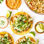 These Vegan Grilled Corn Tostadas are loaded with refried beans, charred corn and a creamy habanero sauce | ThisSavoryVegan.com #thissavoryvegan #vegandinnerideas #vegantostadas