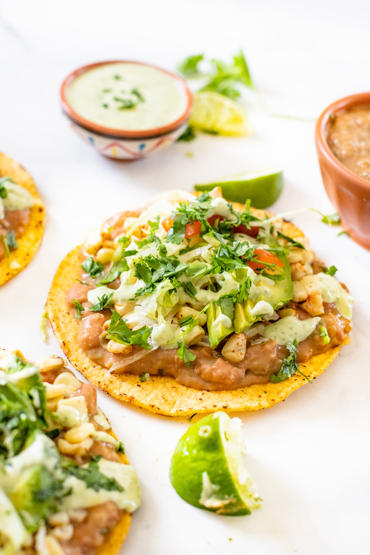 These Vegan Grilled Corn Tostadas are loaded with refried beans, charred corn and a creamy habanero sauce | ThisSavoryVegan.com #thissavoryvegan #vegandinnerideas #vegantostadas