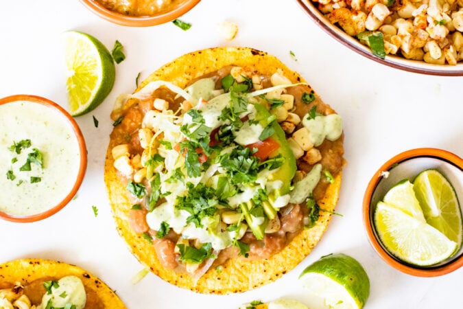 These Vegan Grilled Corn Tostadas are loaded with refried beans, charred corn and a creamy habanero sauce | ThisSavoryVegan.com #thissavoryvegan #vegandinnerideas #vegantostadas