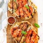 This Grilled Heirloom Tomato Pizza is layered with vegan ricotta, thick slices of heirloom tomatoes, balsamic glaze & fresh basil | ThisSavoryVegan.com #thissavoryvegan #veganpizza #grilledpizza