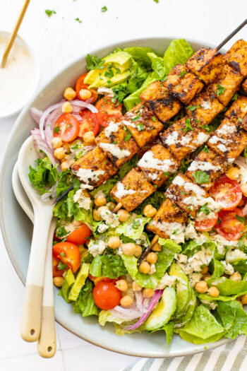 This Grilled Tempeh Greek Salad with Creamy Vegan Greek Dressing is a must make! The perfect vegan salad - restaurant quality at home | ThisSavoryVegan.com #thissavoryvegan #greeksalad #tempehskewers
