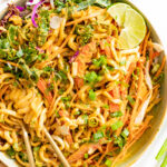 This Red Curry Udon Noodle Salad is made with a spicy tahini red curry sauce, crunchy veggies and cold udon noodles | ThisSavoryVegan.com #thissavoryvegan #tahininoodlesalad #reducurrysauce