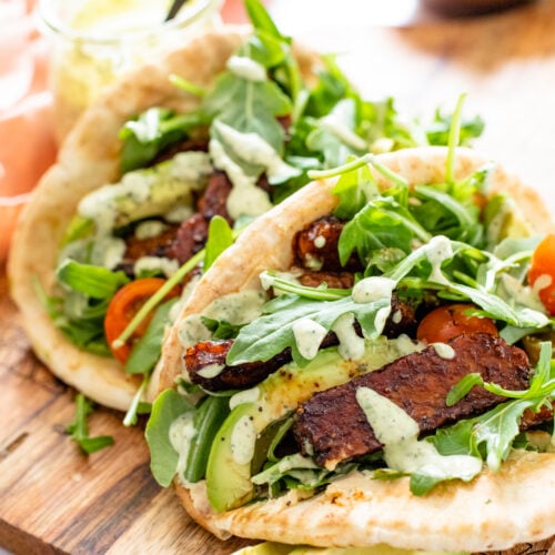 These Tempeh Caesar Salad Pitas are made with the BEST vegan caesar dressing, crispy tempeh and plenty of fresh veggies. Seriously addicting and a great vegan lunch idea | ThisSavoryVegan.com #thissavoryvegan #vegancaesarsalad #veganlunchideas