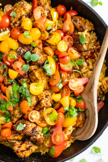 If summer were a dish it would be this Greek Tempeh Orzo Skillet! Fresh tomatoes, basil, orzo, tempeh - cooked in one skillet and totally tasty | ThisSavoryVegan.com #thissavoryvegan #skilletdinner #summervegandinner