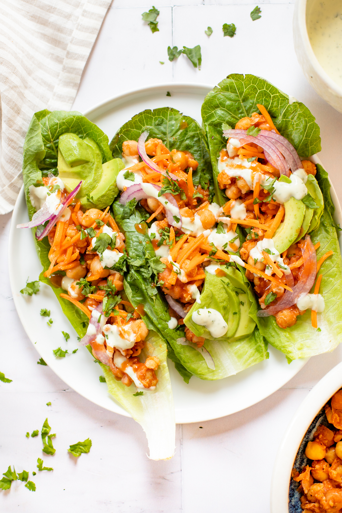 Loaded with avocado, red onion, carrots & vegan ranch - these Buffalo Chickpea Lettuce Wraps are a super easy vegan lunch | ThisSavoryVegan.com #thissavoryvegan #veganlunchideas #lettucewraps