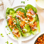 Loaded with avocado, red onion, carrots & vegan ranch - these Buffalo Chickpea Lettuce Wraps are a super easy vegan lunch | ThisSavoryVegan.com #thissavoryvegan #veganlunchideas #lettucewraps