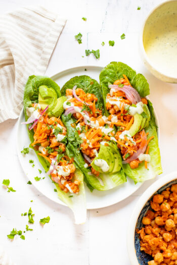 Loaded with avocado, red onion, carrots & vegan ranch - these Buffalo Chickpea Lettuce Wraps are a super easy vegan lunch | ThisSavoryVegan.com #thissavoryvegan #veganlunchideas #lettucewraps