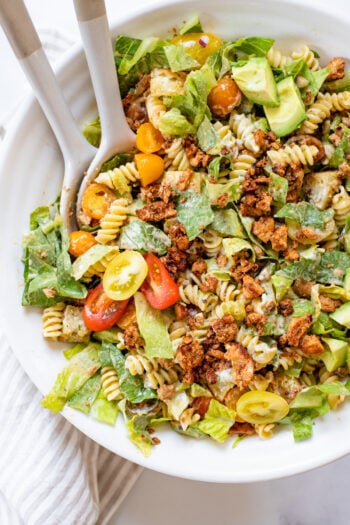 This Vegan Bacon Ranch Pasta Salad is loaded with tofu bacon, romaine, cherry tomatoes, homemade croutons, avocado, red onion and creamy vegan ranch | ThisSavoryVegan.com #thissavoryvegan #veganpastasalad #tofubacon
