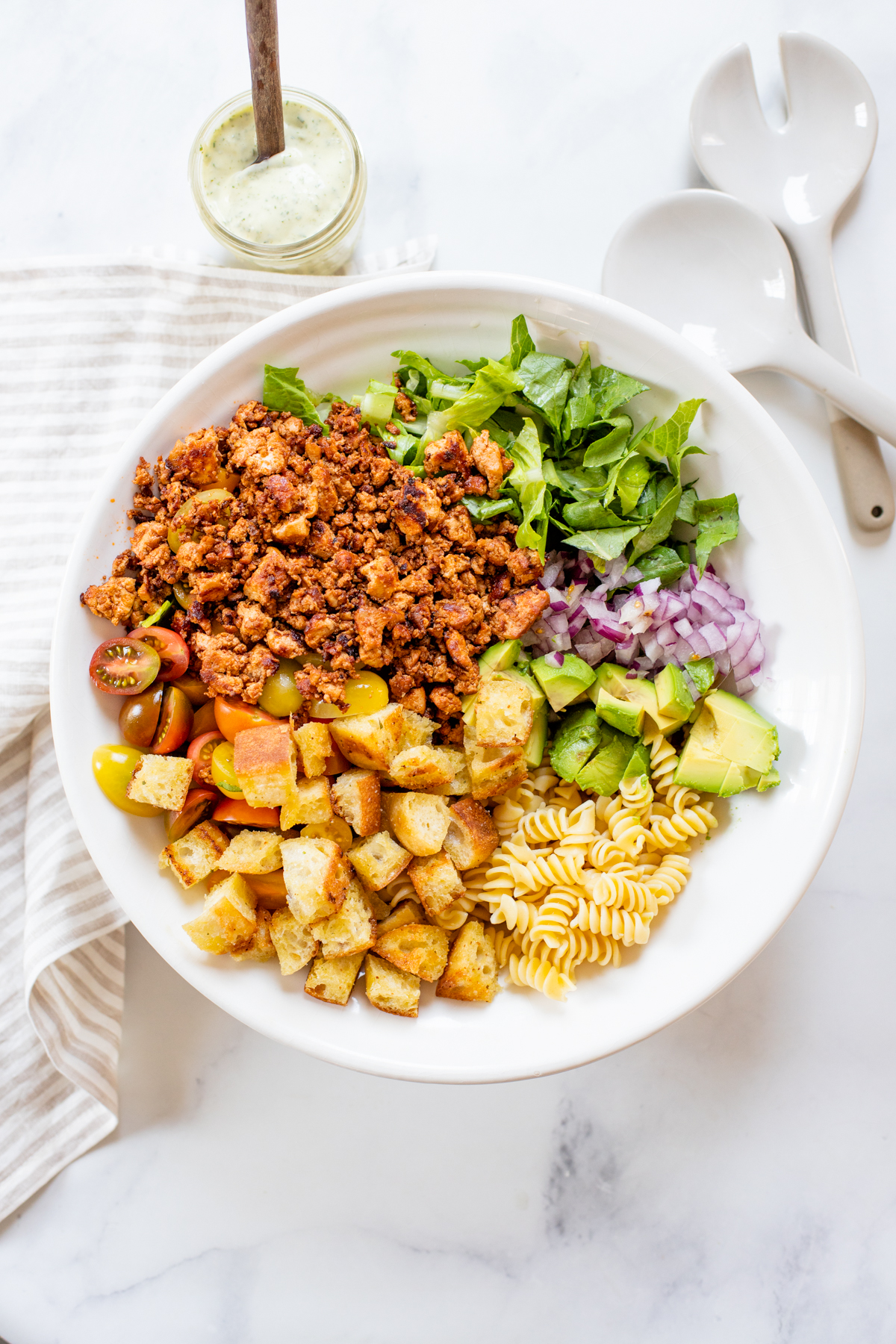 This Vegan Bacon Ranch Pasta Salad is loaded with tofu bacon, romaine, cherry tomatoes, homemade croutons, avocado, red onion and creamy vegan ranch | ThisSavoryVegan.com #thissavoryvegan #veganpastasalad #tofubacon