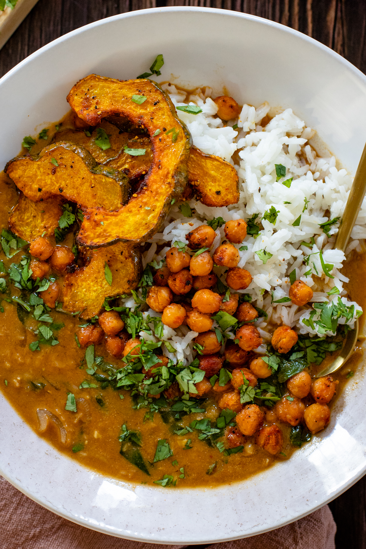 This Acorn Squash Curry with Lentils & Roasted Chickpeas is comfort in a bowl. The roasted squash is divine and the curry is perfectly spicy | ThisSavoryVegan.com #thissavoryvegan #vegancurry #squashrecipes