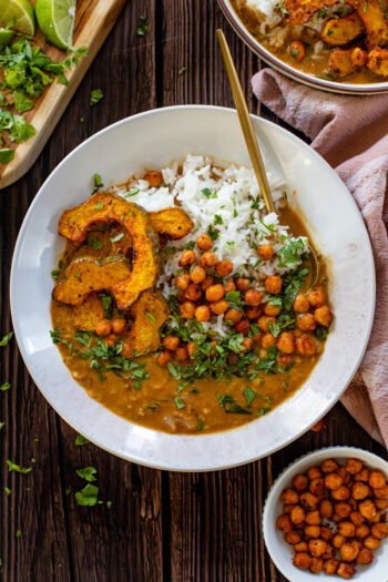 This Acorn Squash Curry with Lentils & Roasted Chickpeas is comfort in a bowl. The roasted squash is divine and the curry is perfectly spicy | ThisSavoryVegan.com #thissavoryvegan #vegancurry #squashrecipes