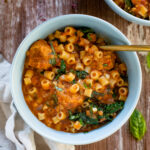 This Vegan Meatball Soup with Pasta & Kale is a hearty and satisfying dinner recipe. Simmered in a flavorful pesto broth | ThisSavoryVegan.com #thissavoryvegan #vegansoup #veganfallrecipes
