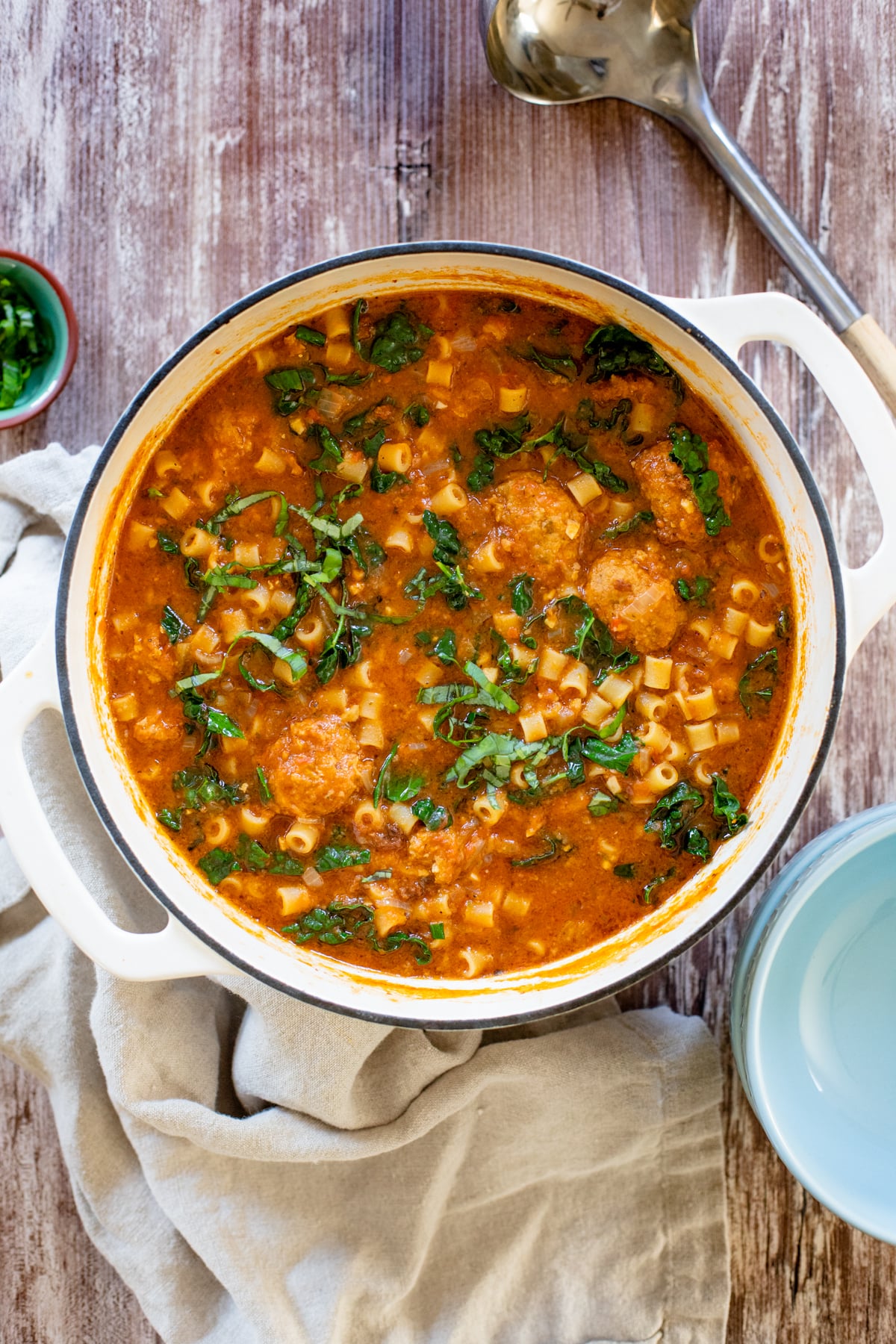 This Vegan Meatball Soup with Pasta & Kale is a hearty and satisfying dinner recipe. Simmered in a flavorful pesto broth | ThisSavoryVegan.com #thissavoryvegan #vegansoup #veganfallrecipes