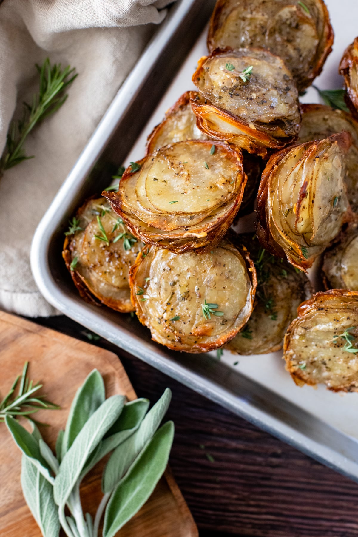 These Crispy Herb Potato Stacks are loaded with thinly sliced potatoes, fresh herbs, vegan butter, vegan parm, garlic salt & pepper. The perfect vegan side | ThisSavoryVegan.com #thissavoryvegan #veganthanksgiving #veganholidayrecipes