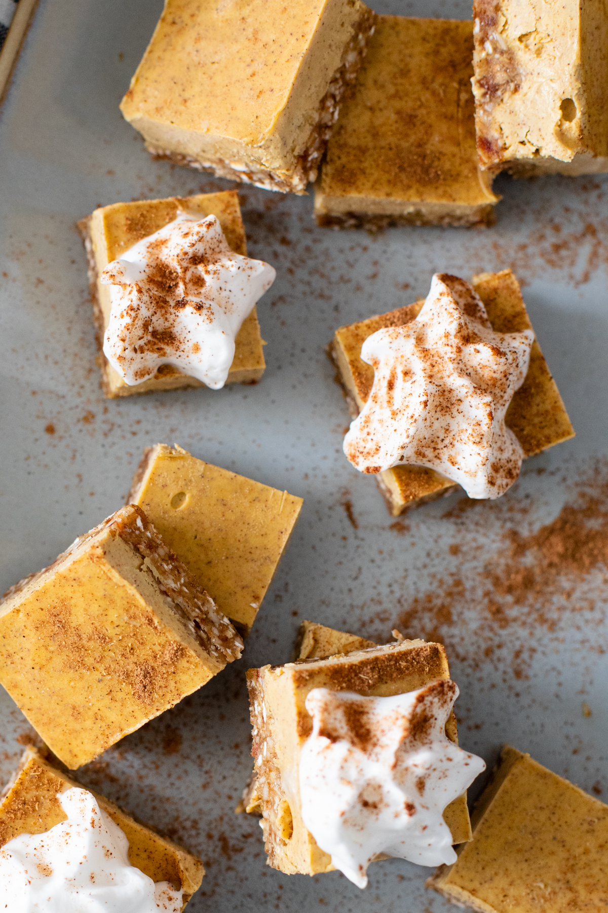 These No-Bake Pumpkin Cheesecake Bars are the perfect vegan dessert. Serve with coconut whipped cream and pumpkin spice on top | ThisSavoryVegan.com #vegandesserts #vegancheesecake #falldesserts