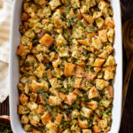 This Vegan Butter & Herb Stuffing is the perfect Thanksgiving side dish! Onions, celery, garlic, fresh herbs and cubed bread all tossed in broth & baked | ThisSavoryVegan.com #thissavoryvegan #veganstuffing #veganthanksgivingrecipes