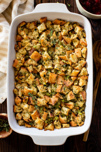 This Vegan Butter & Herb Stuffing is the perfect Thanksgiving side dish! Onions, celery, garlic, fresh herbs and cubed bread all tossed in broth & baked | ThisSavoryVegan.com #thissavoryvegan #veganstuffing #veganthanksgivingrecipes