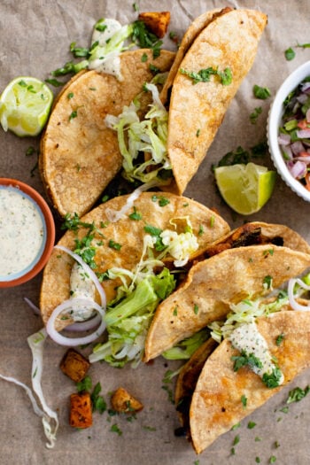These Crispy Poblano & Potato Tacos are the BEST vegan tacos! Crispy shells are loaded with refried beans, roasted potatoes & tender poblano slices. Then they are served up with a creamy vegan sauce | ThisSavoryVegan.com #thissavoryvegan #vegantacos #vegandinnerideas