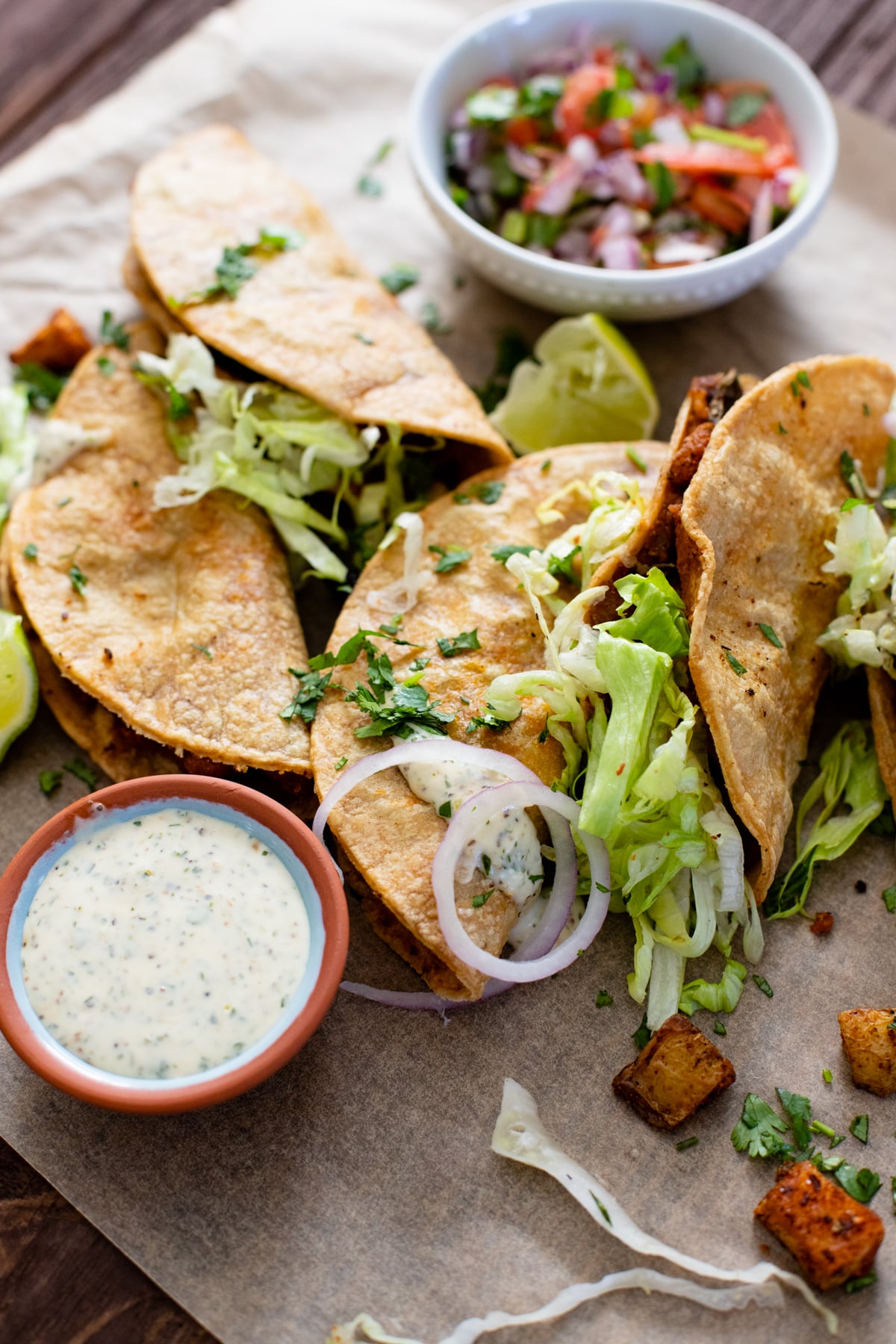 These Crispy Poblano & Potato Tacos are the BEST vegan tacos! Crispy shells are loaded with refried beans, roasted potatoes & tender poblano slices. Then they are served up with a creamy vegan sauce | ThisSavoryVegan.com #thissavoryvegan #vegantacos #vegandinnerideas