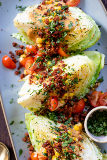 This Southwest Roasted Cabbage Wedge Salad takes the classic to another level - soyrizo, corn, tomatoes, vegan chipotle ranch and lots of cilantro | ThisSavoryVegan.com #thissavoryvegan #vegansalad #vegancabbagerecipes