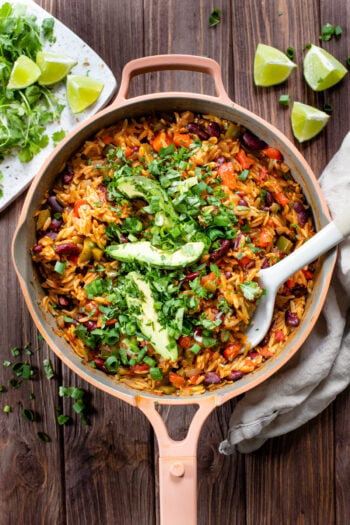 This Cajun Orzo and Bean Skillet is an easy one pot vegan dinner. Filled with veggies, beans, cajun seasonings and orzo pasta | ThisSavoryVegan.com #thissavoryvegan #skilletdinner #onepotdinner