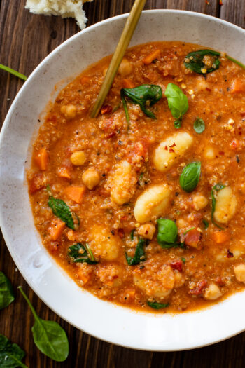 This Creamy Quinoa Gnocchi Soup is the perfect vegan soup. Lots of veggies, a creamy tomato broth, quinoa and pre-made gnocchi | ThisSavoryVegan.com #thissavoryvegan #vegansoup #vegansouprecipes