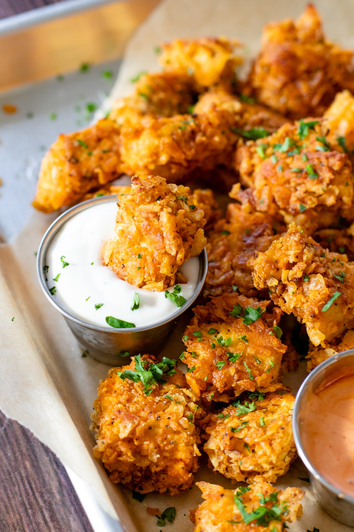 These Spicy Popcorn Tofu Nuggets are seasoned to perfection, battered in potato chip crumbs and served with my favorite bang bang sauce | ThisSavoryVegan.com #thissavoryvegan #tofunuggets #vegannuggets
