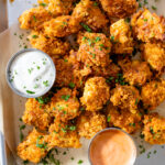 These Spicy Popcorn Tofu Nuggets are seasoned to perfection, battered in potato chip crumbs and served with my favorite bang bang sauce | ThisSavoryVegan.com #thissavoryvegan #tofunuggets #vegannuggets