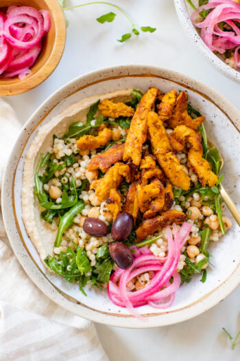 These Vegan Chicken Shawarma Bowls are layered with hummus, couscous salad, pickled red onions, and chicken shawarma made out of soy curls | ThisSavoryVegan.com #thissavoryvegan #veganshawarma #soycurls