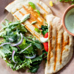 These Vegan Grilled Pita Sandwiches are the perfect lunch! Roasted red peppers, spinach, sun-dried tomatoes, basil aioli and cream cheese | ThisSavoryVegan.com #thissavoryvegan #pitapocket #veganlunchideas