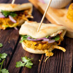 These Red Curry Chickpea Burgers with Tahini Slaw have a crispy burger, crunchy slaw & creamy hummus, all served on a piece of warm naan | ThisSavoryVegan.com #thissavoryvegan #veganburger #veggieburger