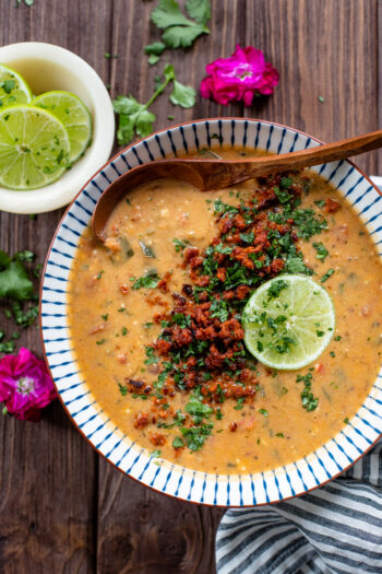 This Poblano Soup with Crispy Soyrizo is filled with beans, spices and veggies. All topped off with crumbled soyrizo, cilantro and a lime wedge | ThisSavoryVegan.com #thissavoryvegan #vegansoup #vegandinnerideas