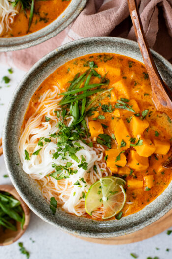 This Sweet Potato Curry Noodle Soup is filled with tender sweet potato chunks, a savory broth and rice noodles. Topped with fresh greens | ThisSavoryVegan.com #thissavoryvegan #noodlesoup #curryrecipe