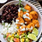 These Coconut Cajun Tofu Bowls are filled with crispy baked tofu, cilantro lime rice, black beans, avocado salsa and a creamy vegan cilantro sauce | ThisSavoryVegan.com #thissavoryvegan #tofubowls #vegandinnerideas