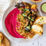 These Grilled Eggplant Skewer Bowls are filled with mediterranean cauliflower rice, roasted beet hummus and a basil aioli - seriously tasty | ThisSavoryVegan.com #thissavoryvegan #veganbowls #hummusbowls