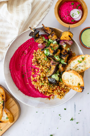 These Grilled Eggplant Skewer Bowls are filled with mediterranean cauliflower rice, roasted beet hummus and a basil aioli - seriously tasty | ThisSavoryVegan.com #thissavoryvegan #veganbowls #hummusbowls