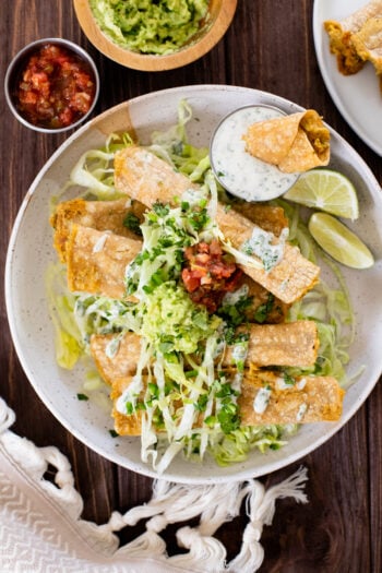 These Green Chile Chickpea Taquitos have a creamy vegan chickpea filling and are served up with vegan jalapeño ranch for dipping | ThisSavoryVegan.com #thissavoryvegan #veganrolledtacos #vegantaquitos