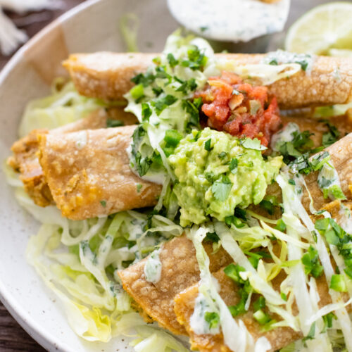 These Green Chile Chickpea Taquitos have a creamy vegan chickpea filling and are served up with vegan jalapeño ranch for dipping | ThisSavoryVegan.com #thissavoryvegan #veganrolledtacos #vegantaquitos