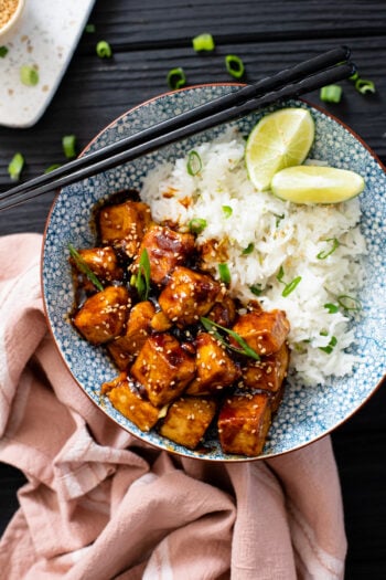 These Korean BBQ Tofu Bowls are filled with crispy, tangy gochujang bbq tofu served over green onion & lime rice. Add veggies for the perfect dinner | ThisSavoryVegan.com #thissavoryvegan #bbqtofu #tofurecipes