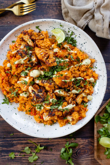 This Roasted Cauliflower with Red Curry Rice is the perfect veggie side dish. The rice is rich & filled with flavor. The cauliflower is perfectly crispy | ThisSavoryVegan.com #thissavoryvegan #redcurry #veggiesidedish